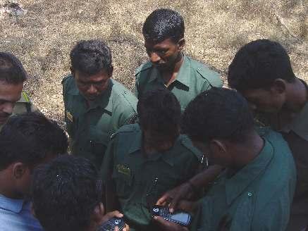 Forest guards operating GPS units