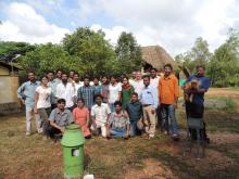 Workshop participants next to a self recording rain-gauge.